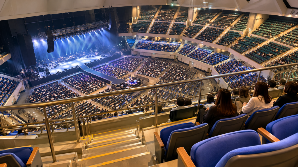 日本武道館の2階スタンド席からコンサートステージとアリーナ全体を見下ろす様子