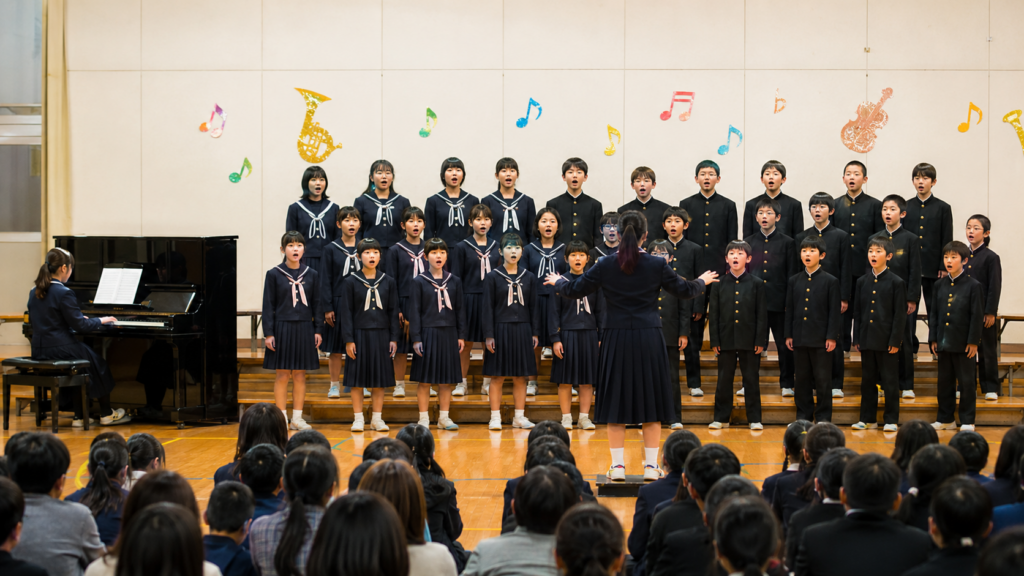 音楽会のステージで心を一つにして合唱する子どもたち